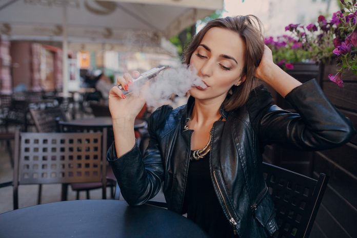 beautiful glamorous brunette smoke electronic cigarette
